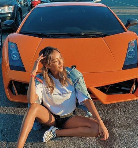 Tayshia Adams poses with her car.